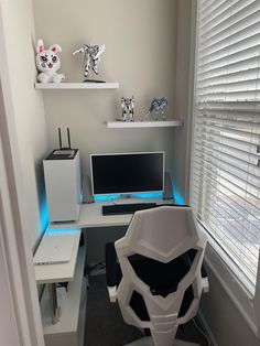 a white desk with two computer monitors on it