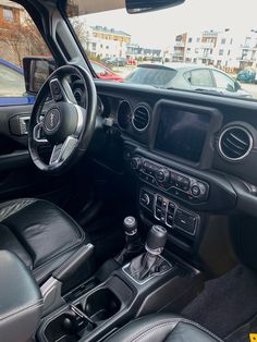 the interior of a car with black leather seats and steering wheel, dash board and dashboard