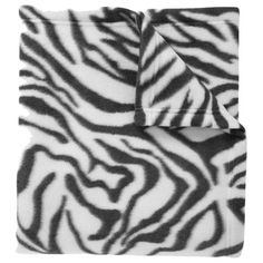 a black and white zebra print blanket on top of a bed