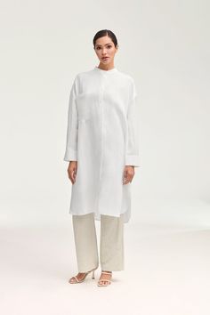 Elevate your summer wardrobe with our luxurious Linen Longline Button Down Top in White. Crafted from cool and breezy linen, this tunic-length cover up is perfect to wear as a standalone piece or a stylish layering option. Embrace effortless elegance in our white button down top. Model is 5'7" and is wearing size XS. White Dress Formal, Dresses Flowy, Nikkah Dress, Engagement Dresses, White Button Down, Kids Outerwear, Dress Satin, Basic Dress, Ribbed Dresses