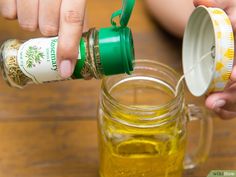 a person is pouring mustard into a jar