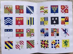 an open book with many different flags and symbols on it's pages, showing the numbers