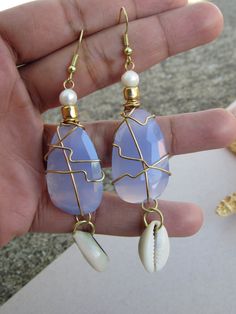 Aqua Chalcedony and freshwater pearl earrings with cowrie shells. Blue Mother Of Pearl Jewelry For Beach, Blue Shell-shaped Handmade Jewelry, Handmade Blue Shell Jewelry, Blue Shell-shaped Jewelry For Vacation, Bohemian Blue Shell-shaped Jewelry, Beach Drop Earrings In Mother Of Pearl, Unique Teardrop Jewelry For Beach, Mother Of Pearl Drop Earrings For Beach, Unique Blue Jewelry For The Beach