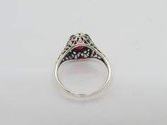 Vintage Sterling Silver Oval cut Ruby Filigree Ring...Marked 925...Total of weights 2.8grams.. Size 9...Measure of Face 10.9mm...It's in very good condition Ornate Oval Ruby Ring With Filigree, Classic Oval Sterling Silver Filigree Ring, Ornate Oval Filigree Ring Stamped 925, Classic Oval Filigree Ring Stamped 925, Oval Silver Ruby Filigree Ring, Oval Silver Ruby Ring With Filigree, Oval Sterling Silver Filigree Ring, Ornate Oval Filigree Ring Hallmarked, Carved Ring