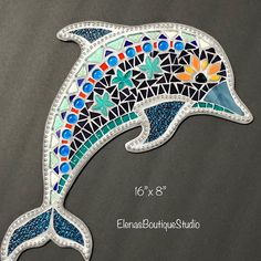 the dolphin is made out of mosaic tiles