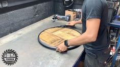 a man working on a cutting board with a circular sawtoothing machine in the background