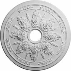 a white ceiling medallion with flowers on it