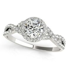 a white gold ring with an oval diamond center surrounded by round brilliant pave diamonds