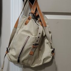 New, Never Used. Open Inside With Zip Pocket And Open Pocket. 2 Outside Zip Pockets. Adjustable Backpack Straps. Size 14x14x5 Non-Smoking Home Casual Canvas Bag With Leather Handles For School, Casual Canvas School Bag With Leather Handles, Casual School Shoulder Bag With Leather Handles, Beige Canvas Bags With Adjustable Straps, Casual Satchel With Leather Handles For School, Casual Satchel With Adjustable Straps For Daily Use, Casual Beige Tote Backpack, Casual Shoulder Bag Backpack With Leather Handles, Casual Beige Backpack For Everyday Use