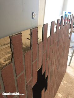 a wall made out of red bricks with holes in it