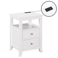 an image of a white night stand with two drawers and a remote control on top