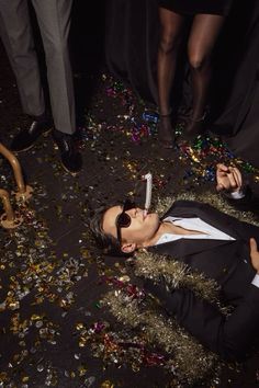 a person laying on the ground with some confetti