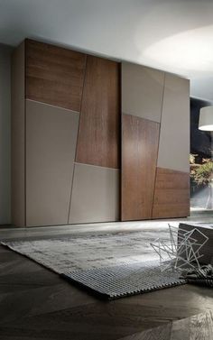 a modern living room with wood paneling and an area rug on the floor in front of it