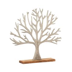 a metal tree sculpture sitting on top of a wooden shelf