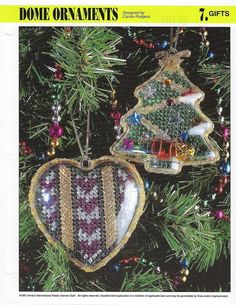 an ornament hanging from a christmas tree in the shape of a heart with a striped design