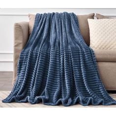 the blue blanket is on top of a couch