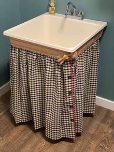 a white sink sitting under a bathroom faucet