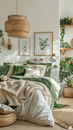 a bed with green sheets and pillows in a room filled with potted plants on the wall