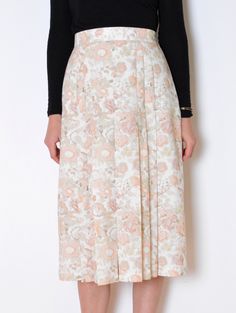 Beautiful vintage midi skirt made of medium-weight fabric with texture a bit similar to flax. White with print of roses, anemones and other flowers in pale pastel tones of pink and beige. High waisted, flared a-line fit with wide pleats. Closes with zip and button on the side. Lined. One extra spare button. Era: 90's, made in England Fabric: 50% viscose, 50% polyester Condition: very good Estimated size: M (please, check the measurements) Measurements (measured flat, need to be doubled to get th Spring Floral Print Midi Pleated Skirt, Spring Floral Midi Pleated Skirt, Spring Floral Print Relaxed Pleated Skirt, Spring Floral Print Full Pleated Skirt, Fitted Pleated Skirt For Spring Daywear, Spring Floral Print Cream Bottoms, Cream Floral Print Bottoms For Spring, Spring Daywear Full Pleated Skirt, Feminine Beige Floral Print Bottoms