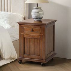 a wooden night stand with a lamp on top