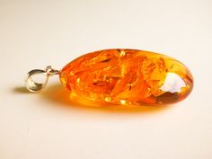 "What an exquisite amber piece - intense shiny cognac color medium size amber pendant with golden rays inside. Shaped into a beautiful oval shape it looks royal and high-value. Its high quality shines as bright as little rays of the sun. MATERIALS AND SIZE: Stone: 100% Natural Baltic Amber Other materials: silver 925 Weight: 13 g (0,45 oz) Pendant size: 4,5 cm (1,77 in) x 2,8 cm (1,10 in) Total length: 5,9 cm (2,32 in) PLEASE NOTE: All our amber production is made of natural amber. Amber is an u Cognac Color, Natural Amber, Oval Pendant, Gift For Wife, Drop Pendant, Baltic Amber, Resin Jewelry, Gifts For Wife, Cognac