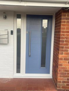 a blue front door on a brick building