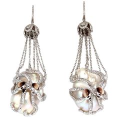 Octopus catch / dangle earrings. 30mm & 29mm natural Freshwater Baroque pearls. GIA Certified White with slight pink overtone. clean clarity, No pits or naturals. 2.00cts of round natural color diamonds: G-color Vs-2 clarity. 2.00ct (4) Natural Cats-Eye Chrysoberyl on eyes. 14kt. white gold 50 grams. Earrings measure 2.9 inch long $27,000 Appraisal Certificate to accompany Luxury Pearl White Dangle Pearl Earrings, Luxury Pearl Drop Dangle Earrings, Luxury Dangle Pearl Earrings, Luxury Oval Pearl Earrings, Luxury Briolette Pearl Earrings, Exquisite Dangle Pearl Earrings For Pierced Ears, Luxury High Luster Pearl White Pearl Earrings, Luxury Drop Pearl Earrings, Exquisite White Pearl Earrings For Evening