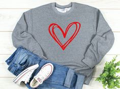 Celebrate Valentine's Day our Sketch Heart Shirt in your choice of short sleeve, long sleeve or crew neck sweatshirt.   The perfect gift for your favorite Valentine. Soft and Comfy with oversized boyfriend fit this heavy weight Gildan Brand sweatshirt will be your new favorite.  Pairs perfectly with jeans or leggings to create a cute cold weather outfit. PLEASE VIEW SIZE CHART PRIOR TO PLACING YOUR ORDER - NO RETURNS ACCEPTED FOR SIZING ISSUES SEND US A MESSAGE WITH ANY SIZING QUESTIONS UNISEX S Love Sweatshirt Design, Sweater Diy, Valentines For Mom, Three Hearts, Cold Weather Outfit, Embroidery Sweater