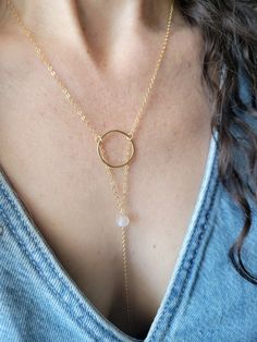 The Moon Beam Necklace features a beautiful petite Moonstone Gem. It is a lariat style necklace and is dainty and feminine! You can wear it so it is tucked into your top like shown or worn out. The circle is hammered and the length of the drop from the top of the circle down to the bottom on the chain is about 5 in. The length shown in the pictures is at a 16 in chain length. Each piece is handmade and may vary slightly as well as the stones as they are natural. Thank you! Dainty Circle Adjustable Necklace, Adjustable Dainty Round Lariat Necklace, Adjustable Round Lariat Necklace In Dainty Style, Adjustable Dainty Lariat Necklace For Layering, Dainty Round Lariat Necklace With Delicate Chain, Adjustable Delicate Chain Lariat Necklace, Adjustable Round Lariat Necklace With Delicate Chain, Adjustable Round Minimalist Lariat Necklace, Adjustable Minimalist Lariat Necklace