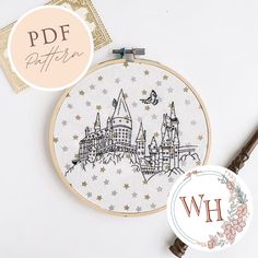 a cross stitch pattern with the letter w in front of it and an embroidered badge next to it