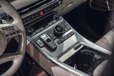 the interior of a car with an automatic gear selector and electronic controls in it's center console