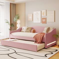 a living room with a pink couch and white rugs on the hardwood flooring