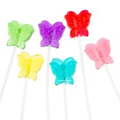 four colorful butterfly lollipops on a white background