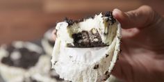 a person holding an ice cream sandwich with oreo cookies on it's side