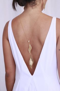 The perfect back necklace for your wedding dress or bridesmaids dresses. Leaf lariat necklace, long and perfect as a back necklace for backless dress. Features two winged leaf elements. The necklace fastens with a unique patented clasp which allows you to wear it in many ways and lengths.- Chain length: 31.5 inches (80 cm)- Leaves length 2-3 inches (5-7 cm)- Made of brass, plated with 24k gold, matte finished or rose gold- Available also in sterling Silver- Packed in a lovely gift box ready to g Lariat Necklace Gold, Bridal Backdrop Necklace, Backdrop Necklace, Unique Bridal Jewelry, Gold Leaf Necklace, Wings Necklace, Gold Backdrop, Backdrops Necklace, Edgy Earrings