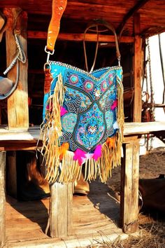 Add a touch of Ibiza magic to your outfit with this unique turquoise bohemian bag. Perfect for festivals, beach trips, and everyday adventures, this bag is designed to make every outfit stand out. Features: Unique Bohemian Turquoise Design: This beautiful embroidered boho bag is adorned with intricate bead trims and decorated with feathers, giving it a special Ibiza vibe. -Premium Materials: Made from blue-colored skin with gold-colored streaks on both the front and back, and trimmed with beauti Colorful Bohemian Bags For Festivals, Bohemian Turquoise Bags For Festival, Beach Cottagecore, Bohemian Multicolor Bag With Colorful Beads, Colored Streaks, Bohemian Multicolor Shoulder Bag With Tassels, Bohemian Turquoise Tote Bag, Turquoise Design, Bohemian Bag