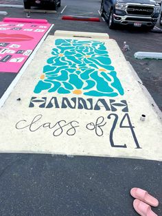 the sidewalk has been painted with various colors and designs on it, including pink flip flops