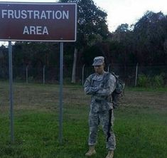 a soldier standing in front of a sign that says frustration area