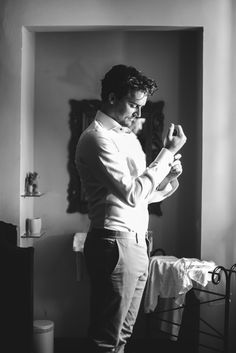 black and white photograph of a man standing in front of a mirror