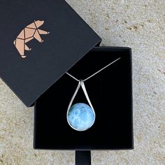 The most beautiful gemstone found only in the Dominican Republic, Larimar is a stone of coolness and calm, much like the native waters it resembles. Larimar is a powerful healer! It can help with panic attacks, anger, fear and other stress-related issues. Secure this unique and beautiful one-of-a-kind incredible Larimar pendant around your neck and breathe in the calm of the Caribbean ocean! A Grade Includes an 18” sterling silver chain Lead-free; nickel-safe Set in 925 sterling silver Pendant is approximately 1.75”H (44.5mm) x 1”W (25.2mm) Comes in our exclusive luxury gift box Source: Dominican Republic Any visible imperfections and/or cracks are due to natural formation Product color may slightly vary due to photographic lighting sources! Disclaimer: Crystals should not be swallowed, gi Caribbean Ocean, Orange Stone, Larimar Pendant, Book Jewelry, The Dominican Republic, Clear Stone, Purple Stones, Luxury Gift Box, Stirling