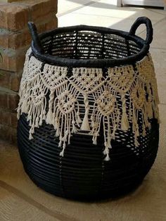 a black and white basket sitting on top of a wooden floor