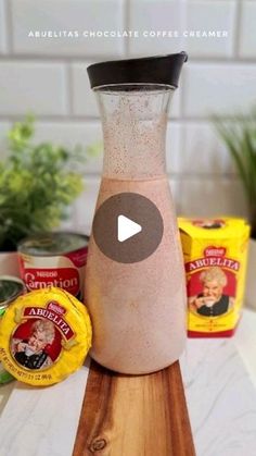 a blender filled with coffee sitting on top of a wooden cutting board next to other ingredients