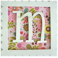 the letter d is made up of flowers and leaves on pink paper with white border