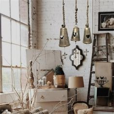 a room filled with furniture and bells hanging from the ceiling