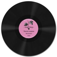 a vinyl record with the words simple things written in pink and black ink on it