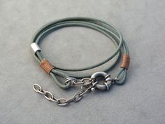 Embrace a touch of rustic elegance with our handcrafted leather bracelet, designed to wrap comfortably around your wrist. Made from high-quality leather in a versatile green-gray hue, this adjustable bracelet features unique metal accents and meticulous hand-woven details. Ideal for both casual and formal occasions, this bracelet is a timeless piece that enhances your individuality. Its adjustable clasp ensures a perfect fit for any wrist size, making it a thoughtful gift for loved ones or a spe Rustic Waxed Cord Bracelets As Gift, Casual Jewelry With Leather Strap As Gift, Casual Jewelry With Leather Strap Gift, Leather Bracelets With Adjustable Cord As Gift, Leather Adjustable Cord Bracelet Gift, Rustic Adjustable Leather Bracelet With Waxed Finish, Adjustable Waxed Finish Bracelets For Everyday, Rustic Adjustable Bracelet With Waxed Finish, Adjustable Rustic Leather Bracelet For Everyday