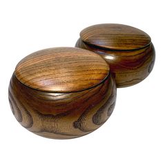 two wooden bowls sitting on top of each other