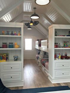 a bedroom with bunk beds and built - in bookshelves on the ceiling is shown