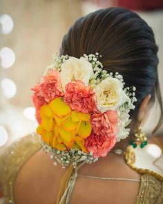 a woman with flowers in her hair is wearing a flowered headpiece on her wedding day