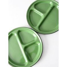 two green plastic plates sitting next to each other